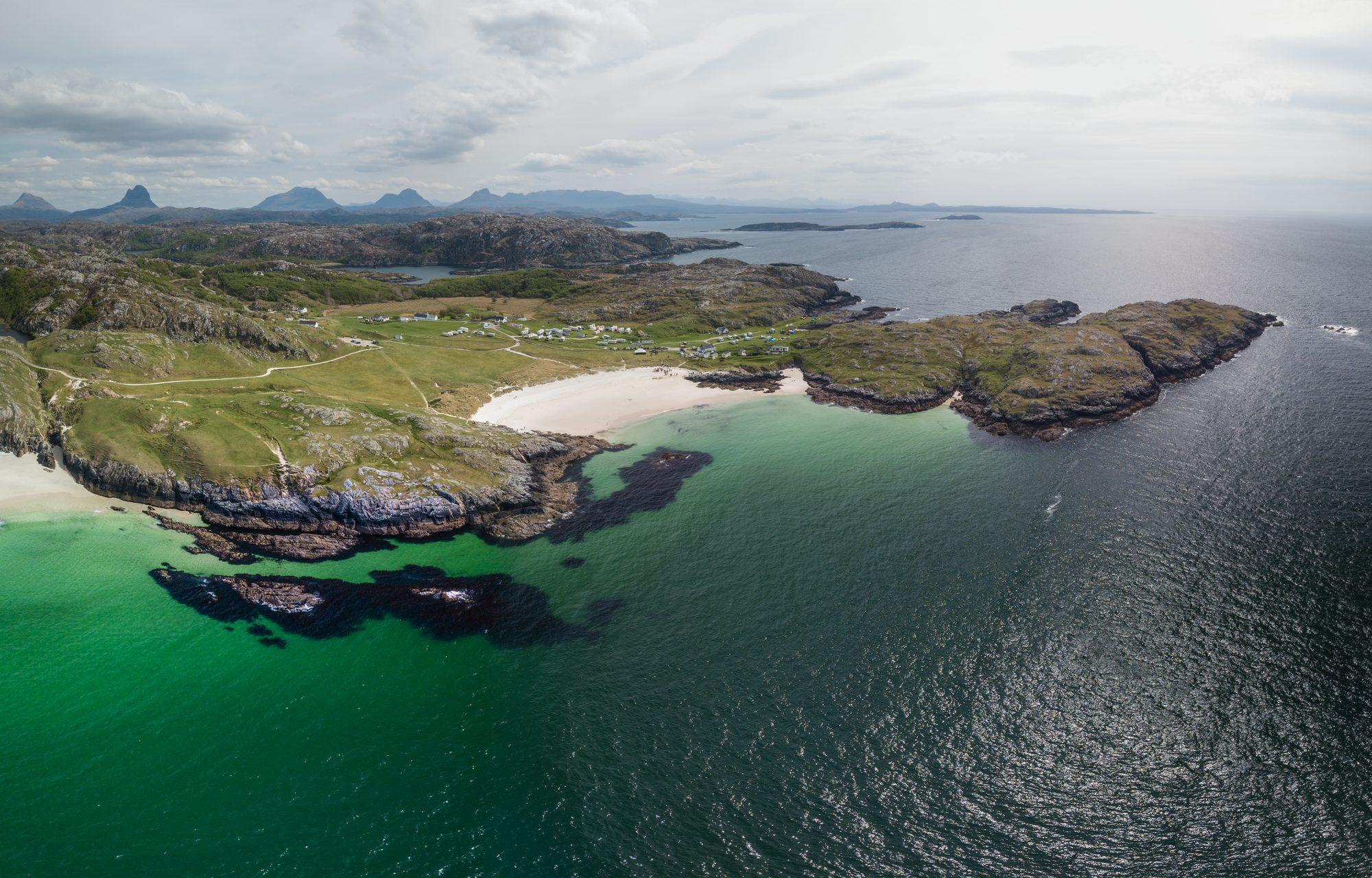 Aerial view of a turquoise bay and rugged coastline