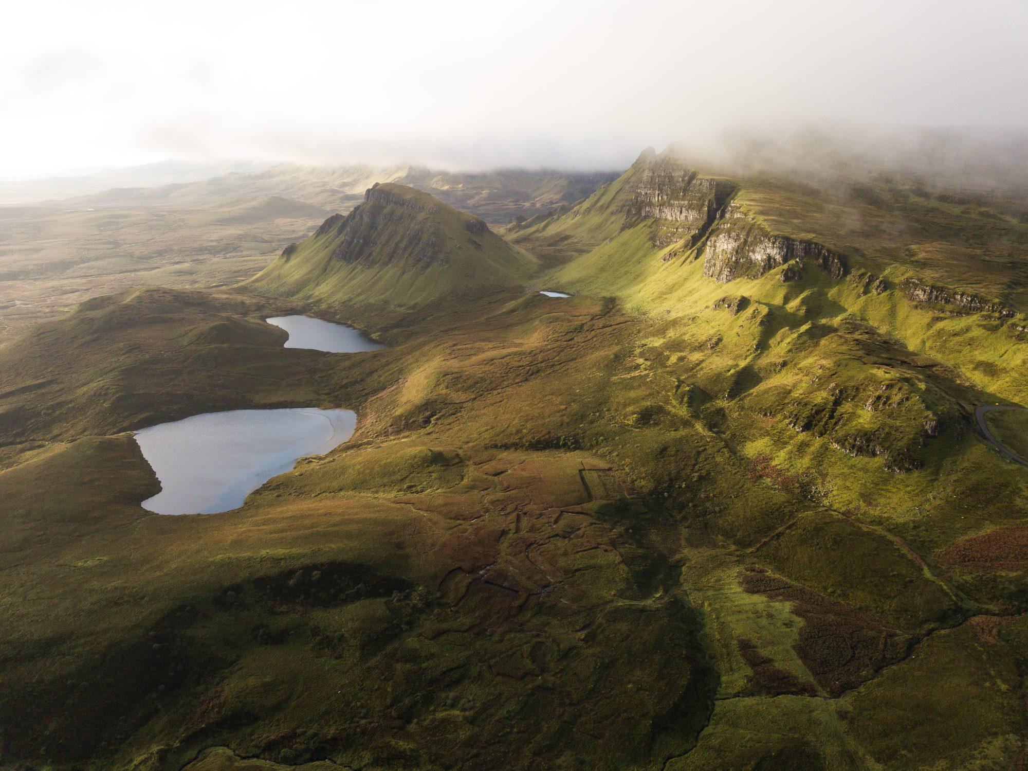 Aerial view of green Highland hills dotted with lochans