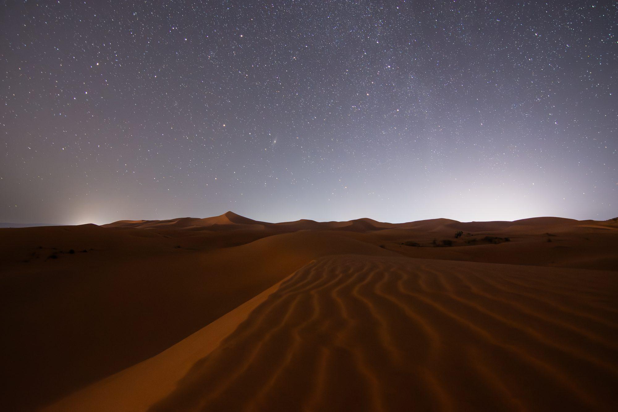Wind-sculpted desert dunes at night